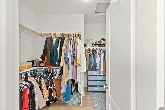 a front view of a house with a large tree