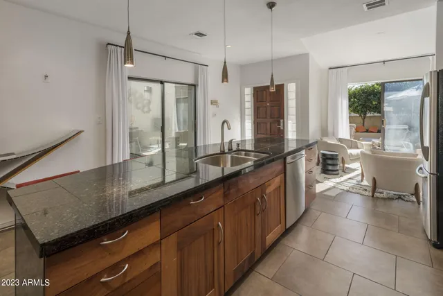 a large kitchen with kitchen island a large counter space and stainless steel appliances