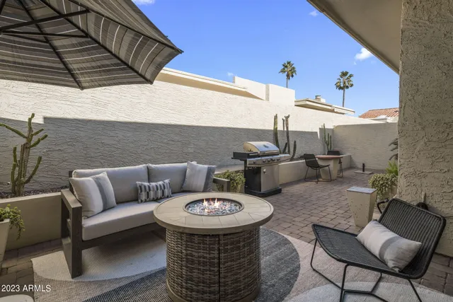 a balcony with table and chairs