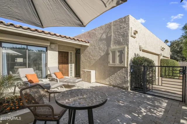 a view of house with backyard outdoor seating and patio