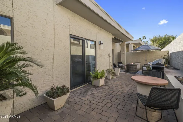 a view of a patio with couches and potted plants