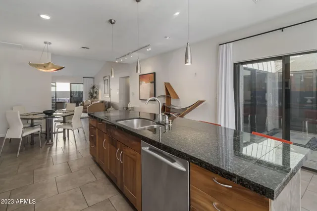 a kitchen with counter top space a sink and stainless steel appliances