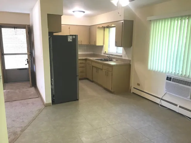 a kitchen with a refrigerator and window