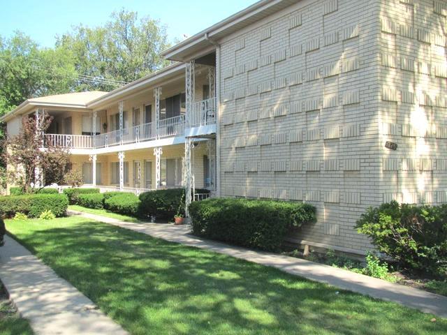 725 Busse Highway, Unit 10 Park Ridge, IL 60068 - Photo 2 of 37 a front view of a house with a yard and garage
