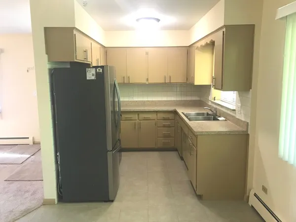 a kitchen with a refrigerator and a sink