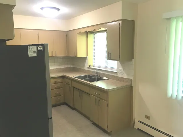 a kitchen with a sink and a refrigerator