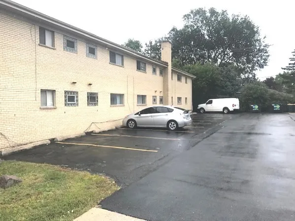 a view of a car park in front of a house