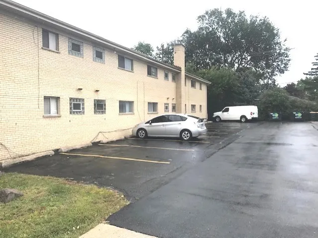 a view of a car park in front of a house
