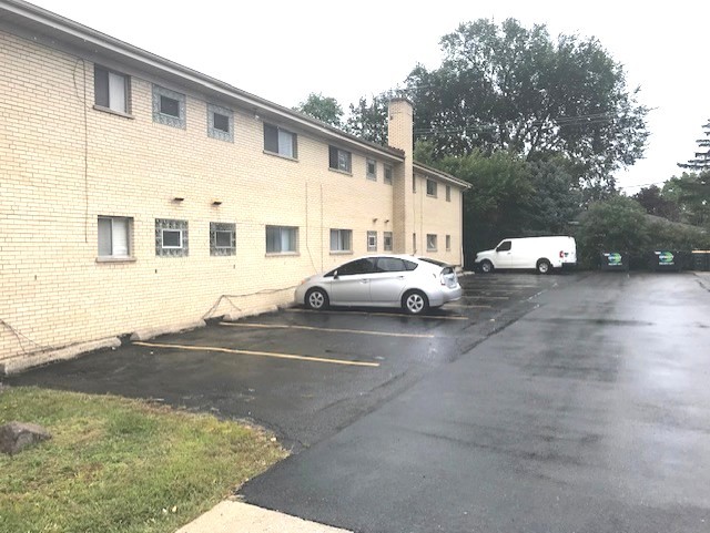 725 Busse Highway, Unit 10 Park Ridge, IL 60068 - Photo 3 of 37 a view of a car park in front of a house
