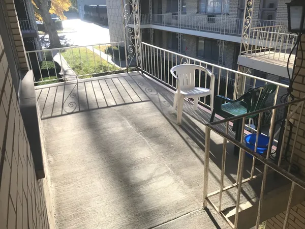 a view of balcony with wooden floor