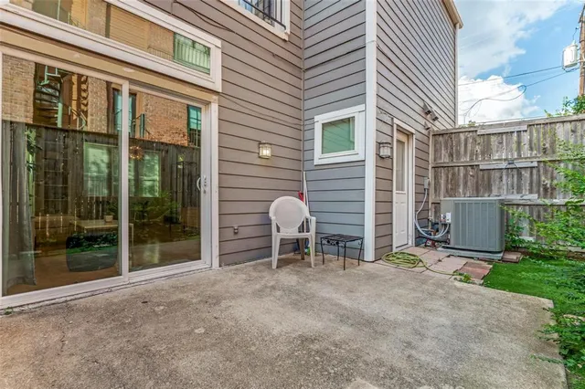 a backyard of a house with barbeque oven and table
