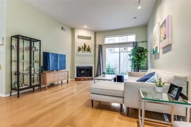 a living room with furniture large window and a fireplace