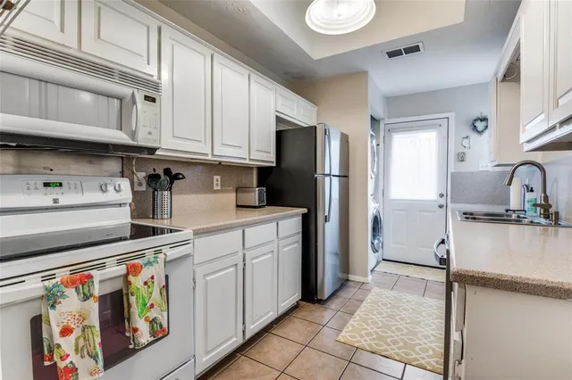 a kitchen with stainless steel appliances granite countertop a sink and cabinets