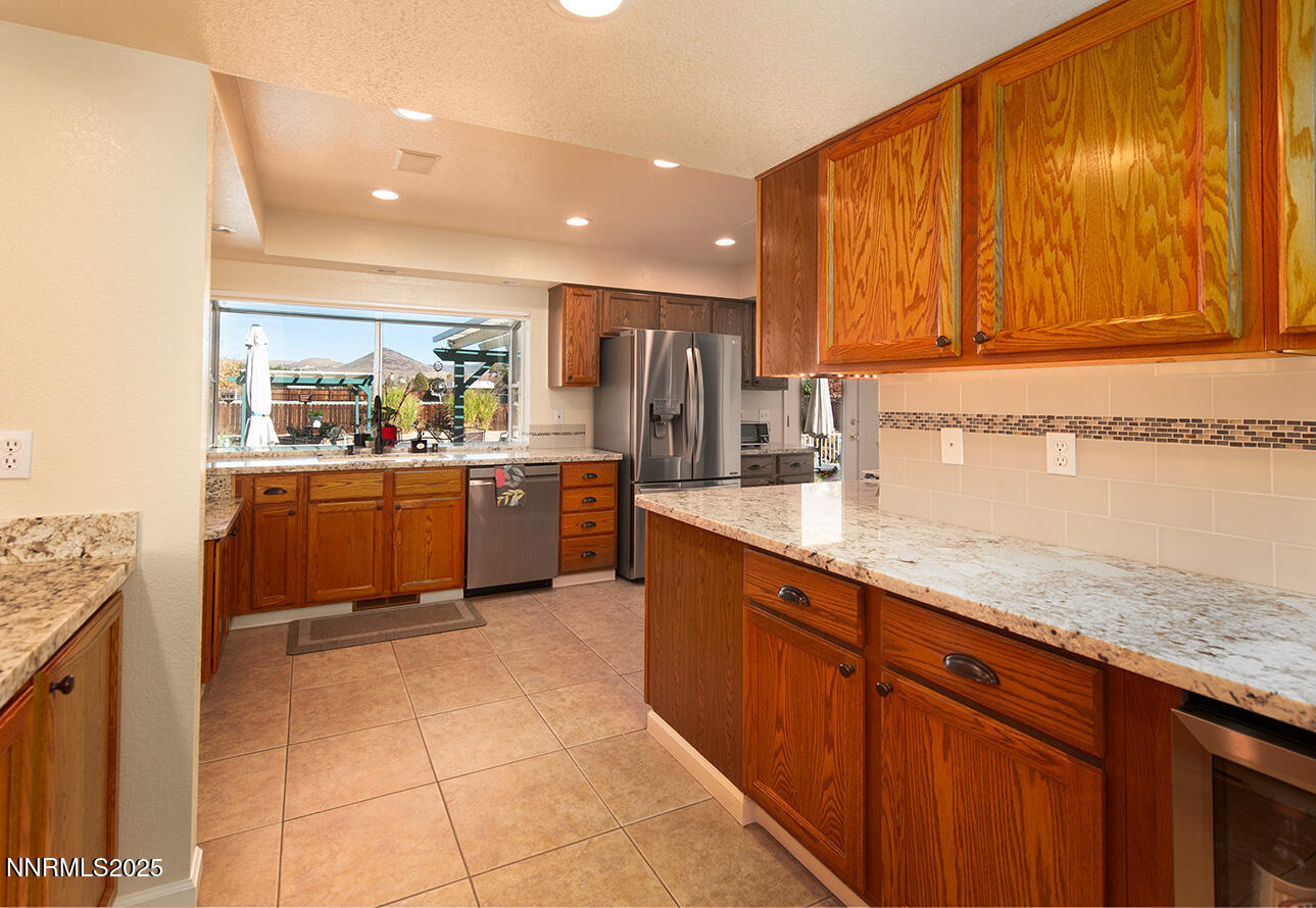 25 Nives Court Sparks, NV 89441 - Photo 13 of 67 a kitchen with stainless steel appliances granite countertop a sink and cabinets