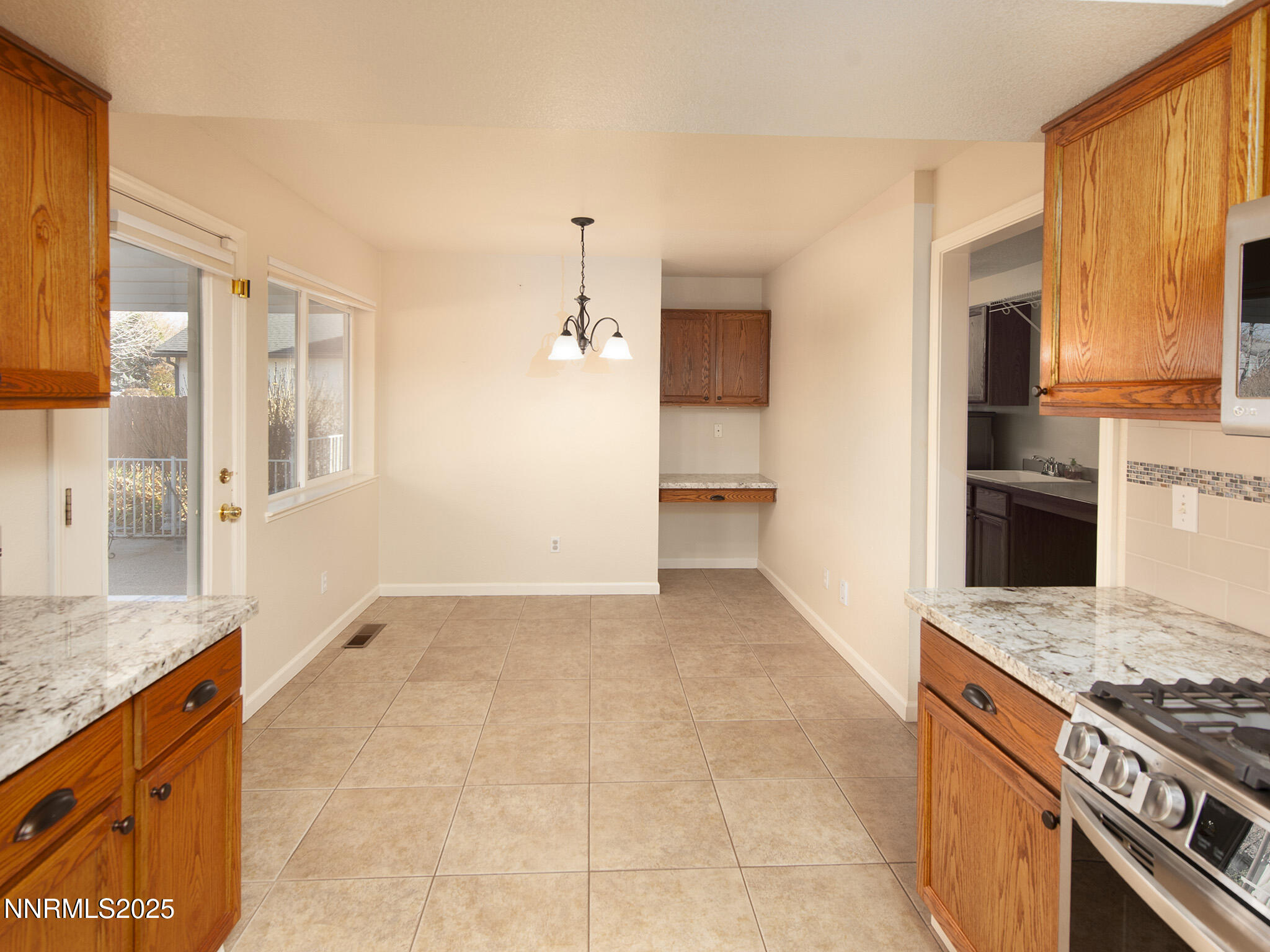 25 Nives Court Sparks, NV 89441 - Photo 15 of 67 a kitchen with stainless steel appliances granite countertop a stove and a refrigerator
