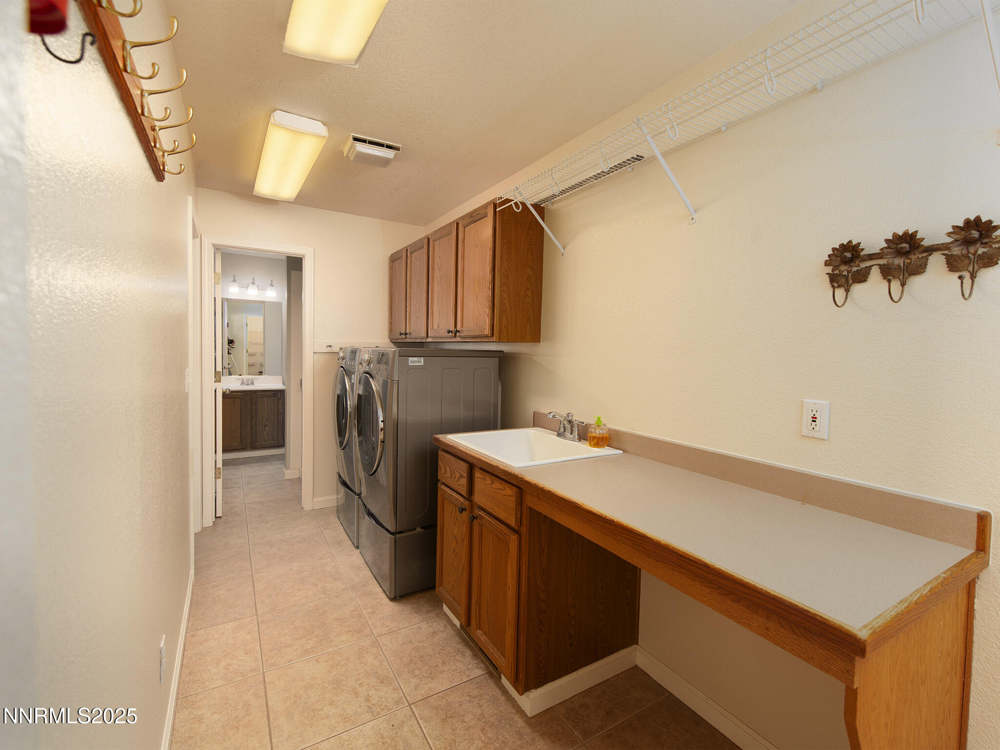 25 Nives Court Sparks, NV 89441 - Photo 31 of 67 a utility room with a sink a washer and dryer