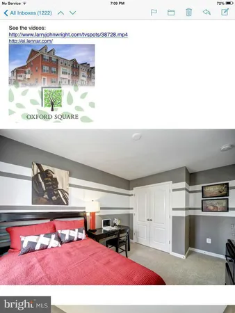 a living room with stainless steel appliances furniture and a flat screen tv