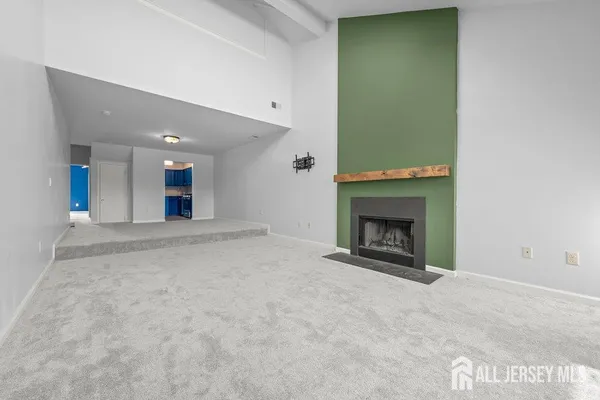 a view of an empty room with a fireplace