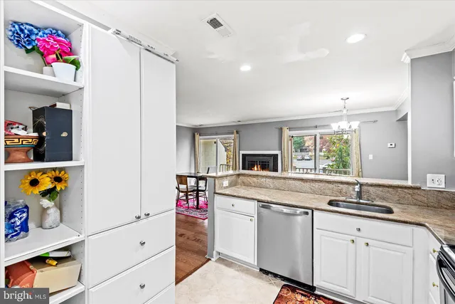 a kitchen with granite countertop a sink stainless steel appliances and cabinets