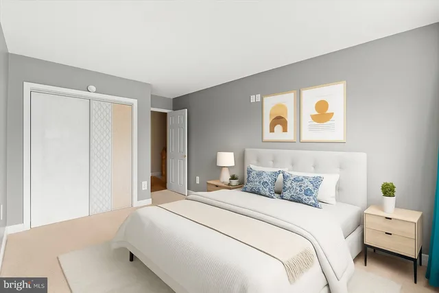 a bedroom with a bed and a painting on the wall