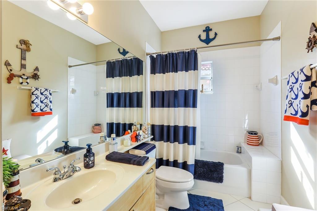 8133 Chancel Court, Unit 641 Naples, FL 34104 - Photo 11 of 13 a bathroom with a sink toilet and shower