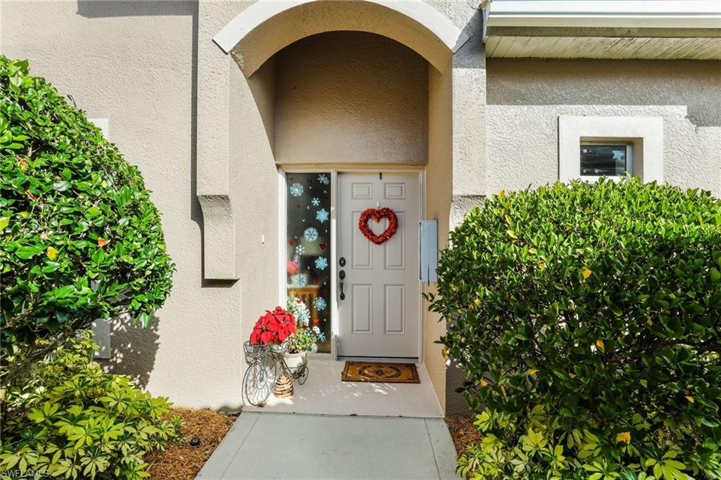 8133 Chancel Court, Unit 641 Naples, FL 34104 - Photo 3 of 13 an aerial view of a house with fountain and potted plants
