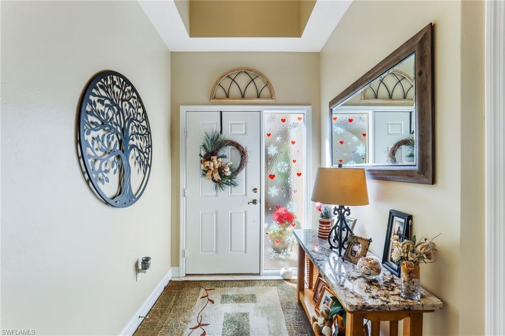 8133 Chancel Court, Unit 641 Naples, FL 34104 - Photo 4 of 13 a view of an entryway with wooden floor