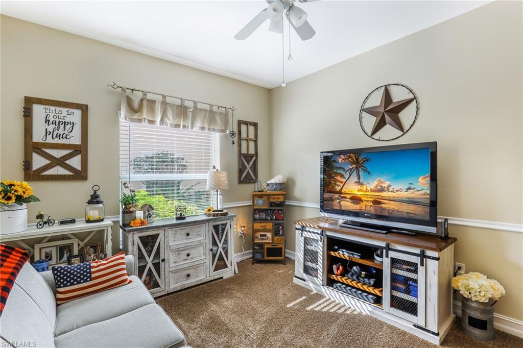 8133 Chancel Court, Unit 641 Naples, FL 34104 - Photo 6 of 13 a room with furniture and a flat screen tv