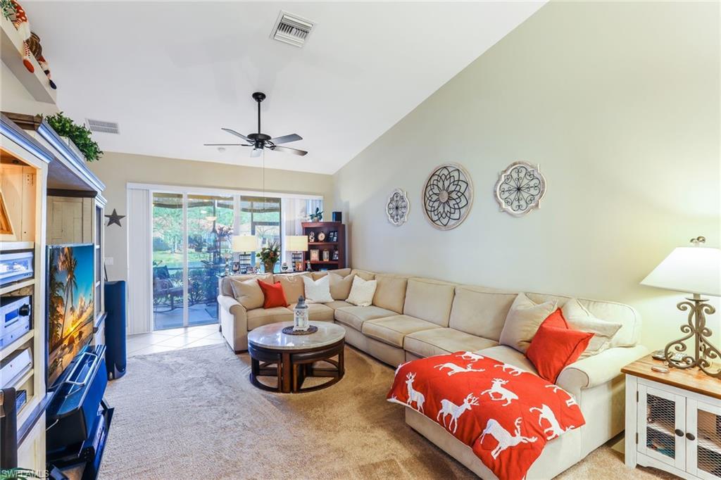 8133 Chancel Court, Unit 641 Naples, FL 34104 - Photo 7 of 13 a living room with furniture and a flat screen tv