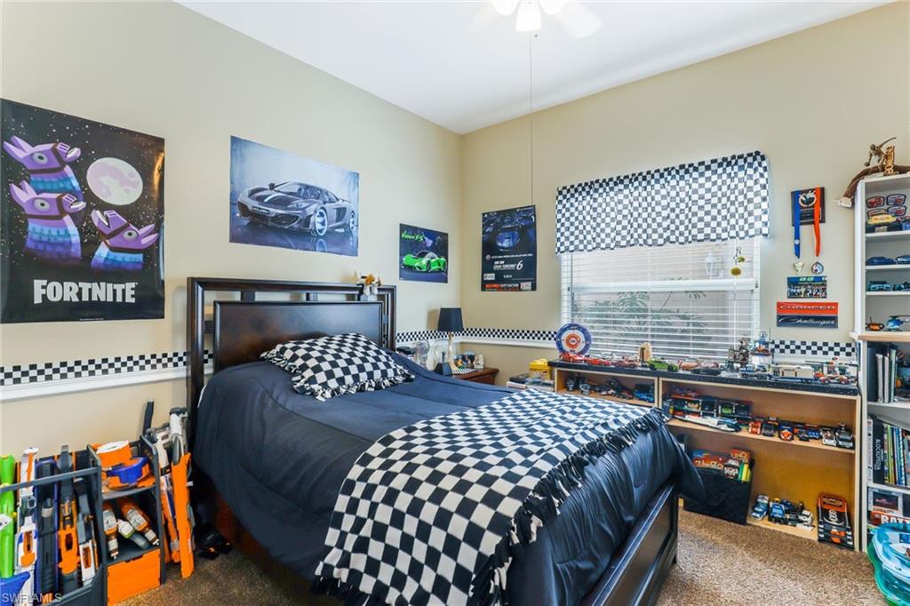 8133 Chancel Court, Unit 641 Naples, FL 34104 - Photo 10 of 13 a bedroom with furniture and a baby crib
