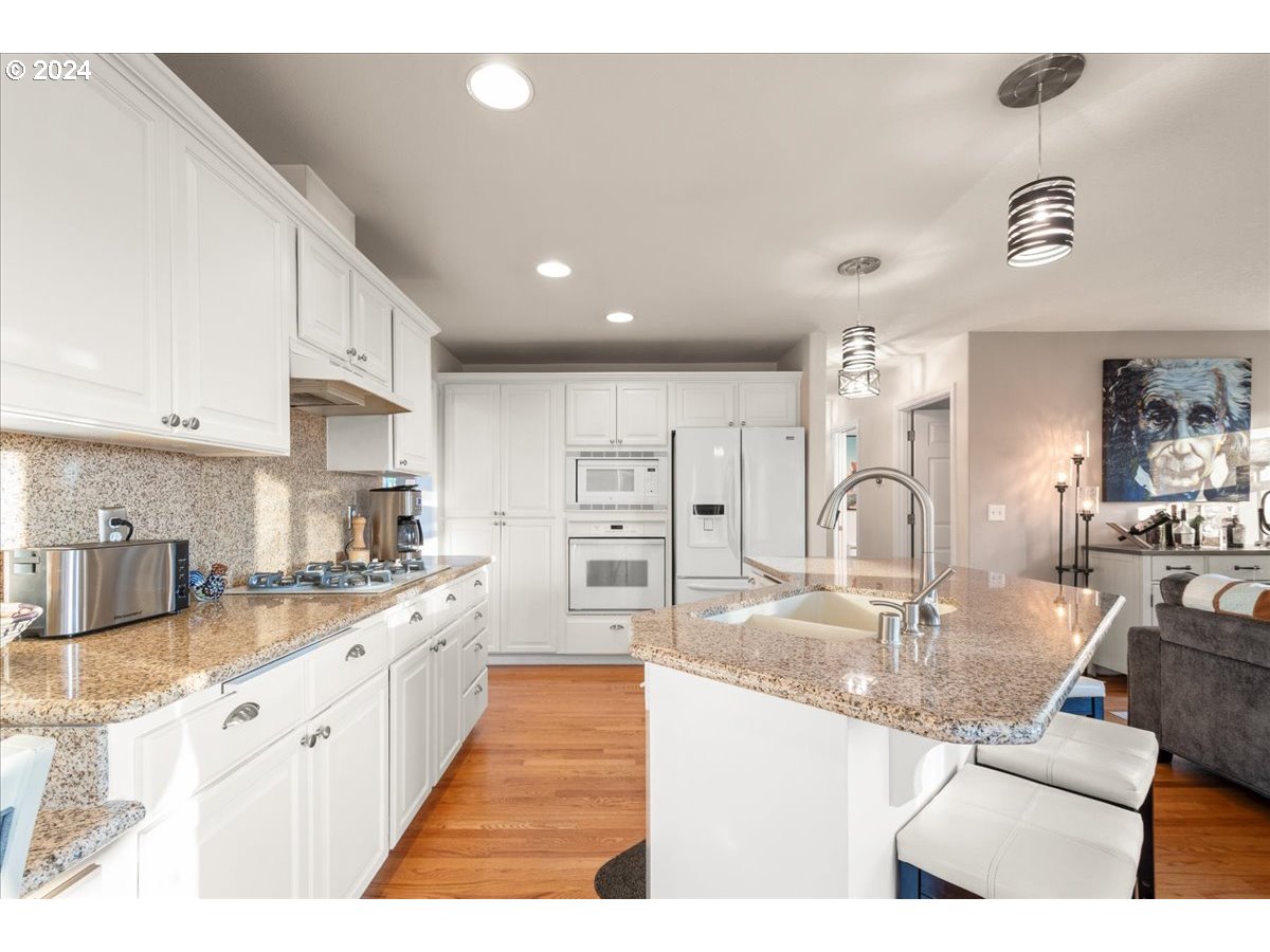 2509 Northwest 36th Avenue Camas, WA 98607 - Photo 13 of 48 a large kitchen with stainless steel appliances kitchen island granite countertop a sink and cabinets
