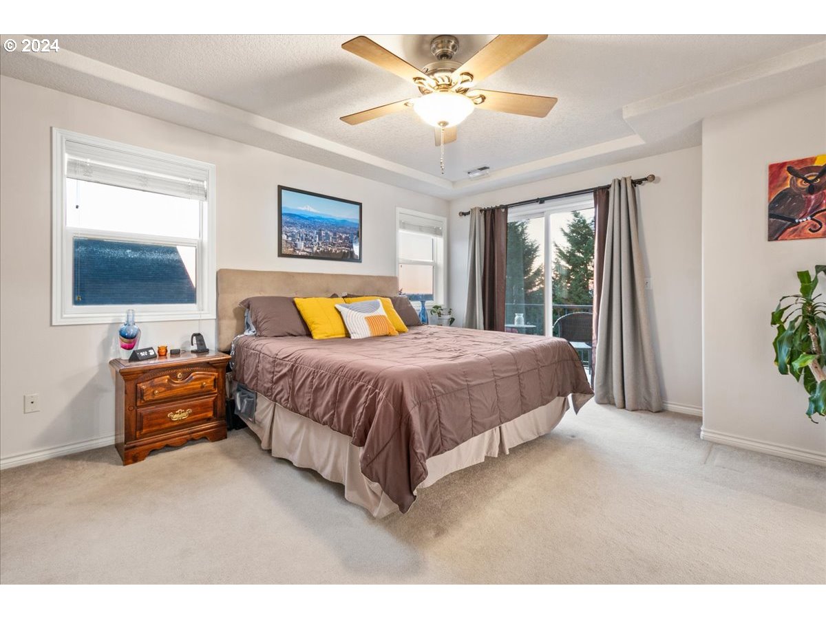 2509 Northwest 36th Avenue Camas, WA 98607 - Photo 24 of 48 a spacious bedroom with a bed and a chandelier