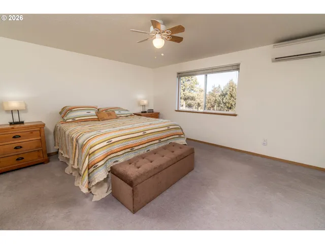 a bedroom with bed and window