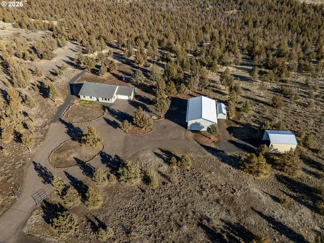 an aerial view of residential house with parking