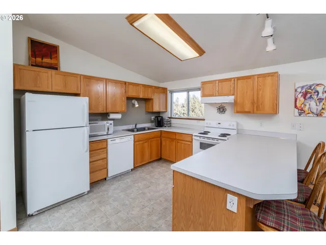 a kitchen with a sink appliances and cabinets