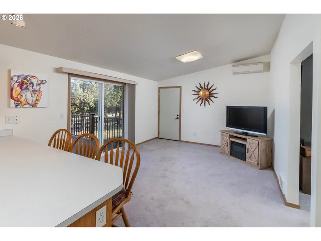 a living room with furniture tv and a window