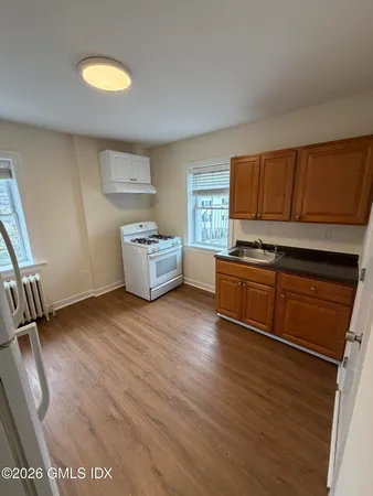 a kitchen with a cabinets and wooden floor