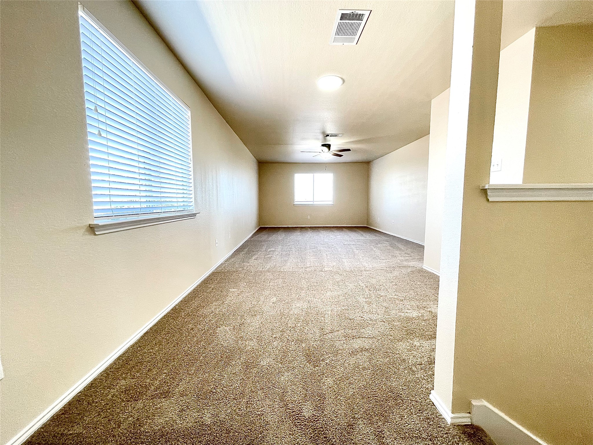 508 Emma Rose Trail Leander, TX 78641 - Photo 39 of 40 An airy upper-level area offers versatile space, illuminated by windows and overhead lighting.