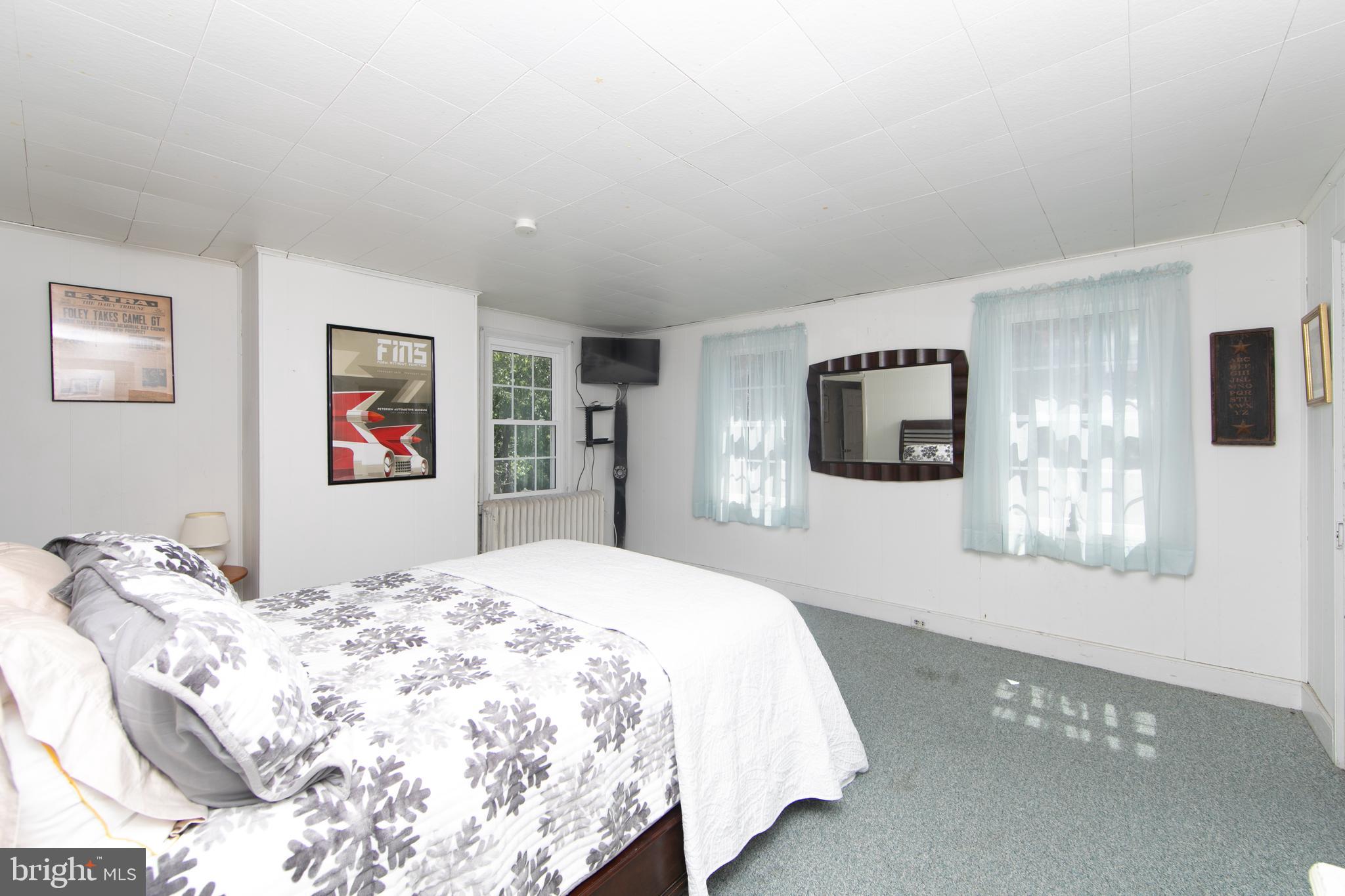 86 Kansas Road Pennsville, NJ 08070 - Photo 26 of 46 a bedroom with a large bed and a flat screen tv