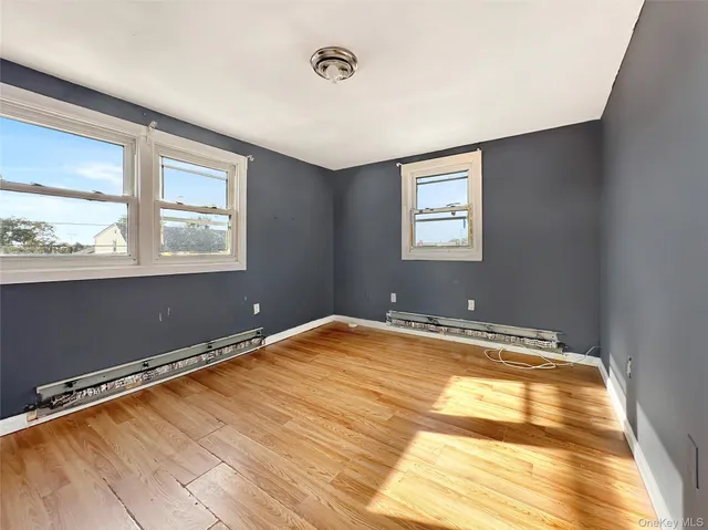 a view of a room with wooden floor and window