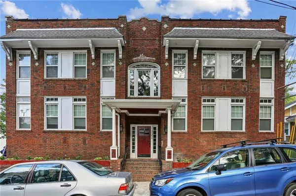 a front view of a house with parking space
