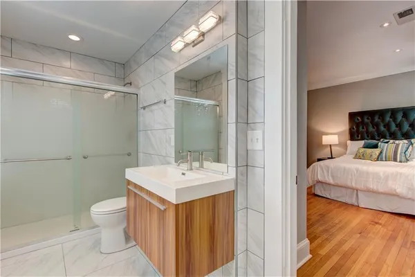 a bathroom with a sink a toilet and shower