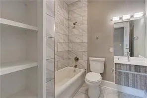 a bathroom with a toilet a sink a mirror a bathtub and shower