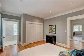 a bedroom with a bed and a wooden floor