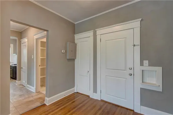 a view of a hallway with wooden floor