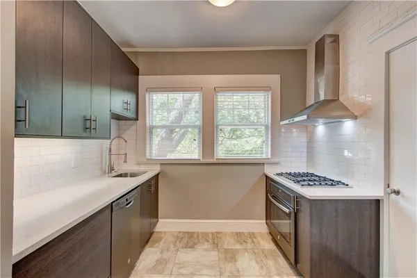 a view of kitchen with sink cabinets and a window