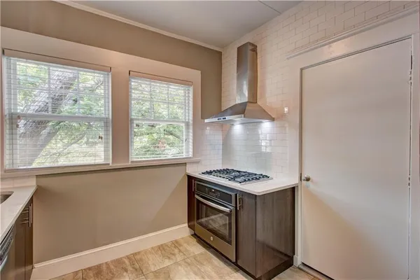 a kitchen with a stove and a window