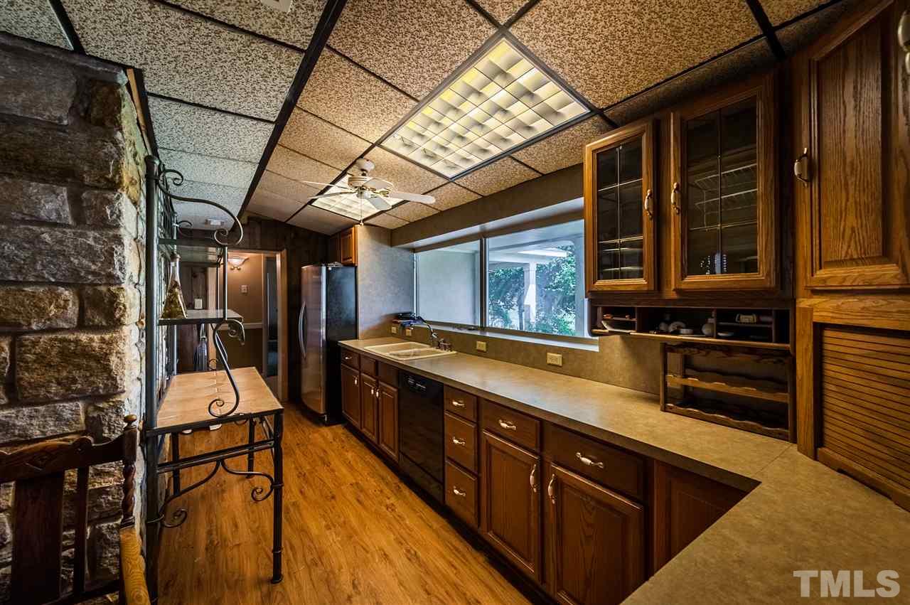 4308 Ryegate Drive Raleigh, NC 27604 - Photo 12 of 23 a large kitchen with stainless steel appliances wooden cabinets and a stove top oven