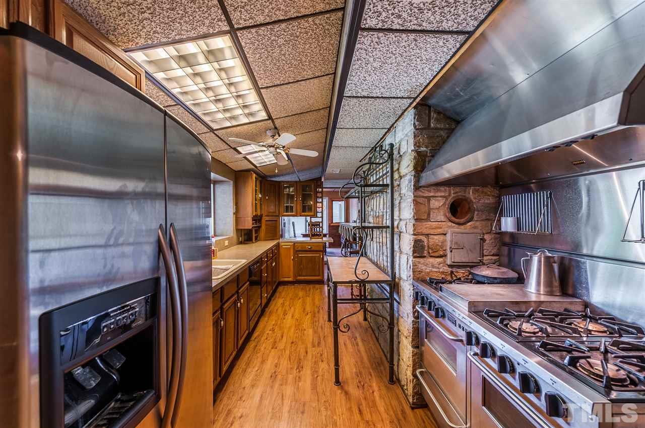 4308 Ryegate Drive Raleigh, NC 27604 - Photo 13 of 23 a kitchen with a stove and a wooden floors