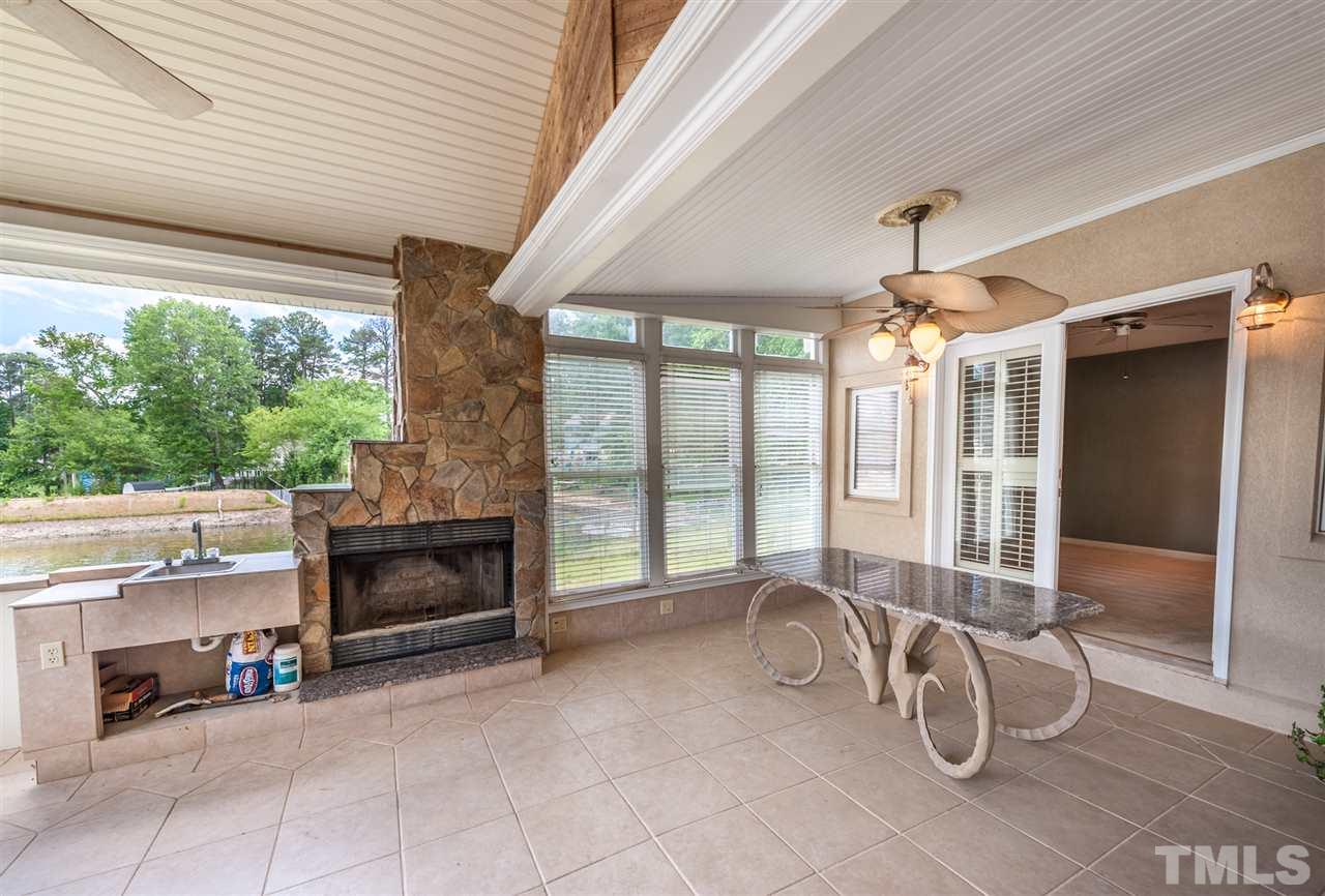 4308 Ryegate Drive Raleigh, NC 27604 - Photo 16 of 23 a living room with furniture a fireplace and a floor to ceiling window